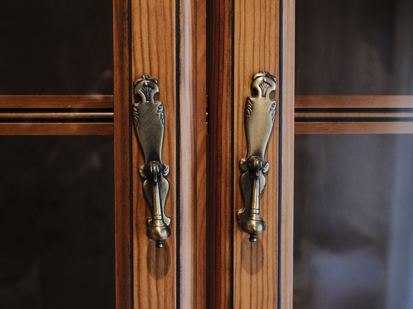 Brass handles on restored wood cabinet